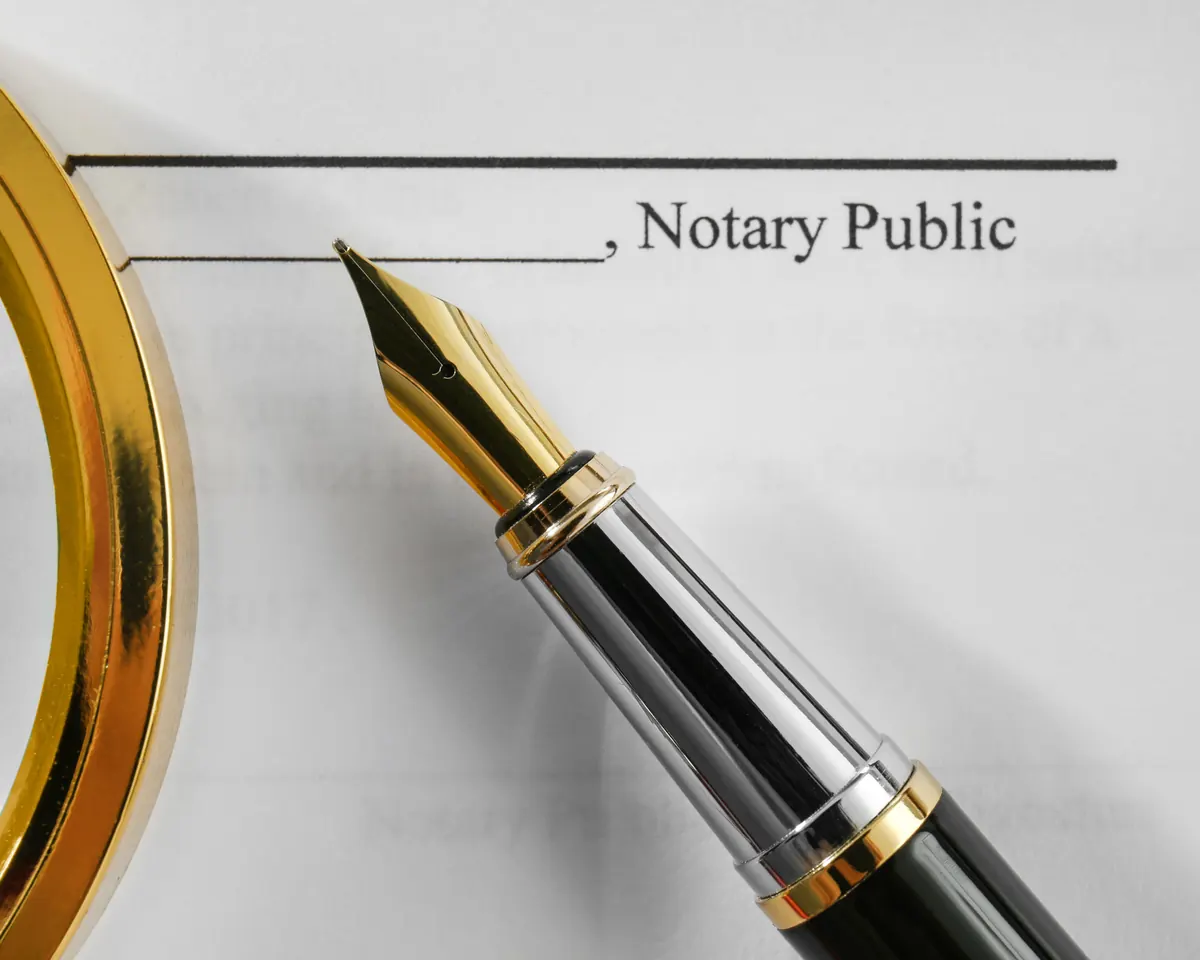 Fountain pen resting on a notary signature line